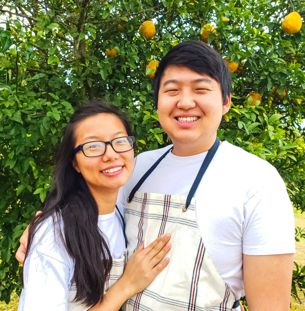Head shot of Mei and Kyong wearing plaid aprons.