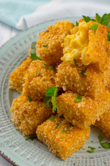 a plateful of mac and cheese bites sprinkled with chopped parsley