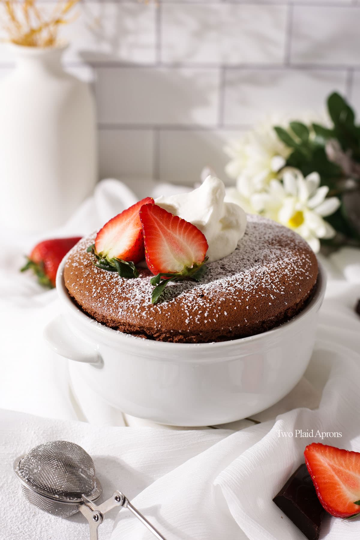 Flourless chocolate soufflé with strawberries, chocolate chips, and chocolate ganache.