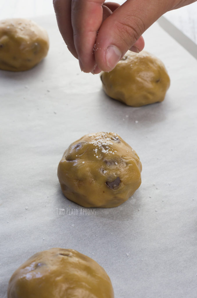 Sprinkling some flaked salt on the cookie dough balls.