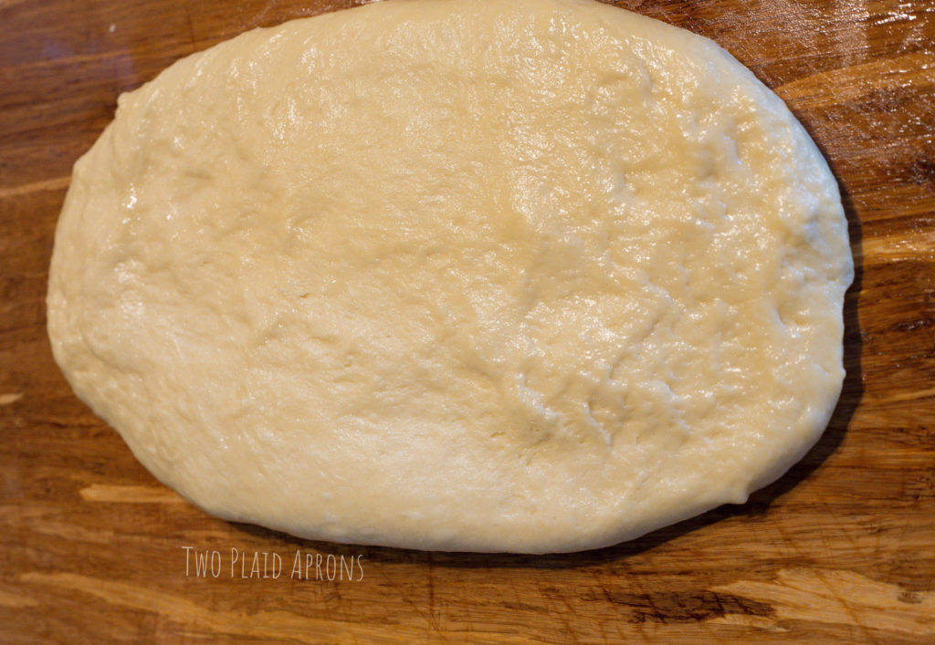 Flatten dough into an oval disc.