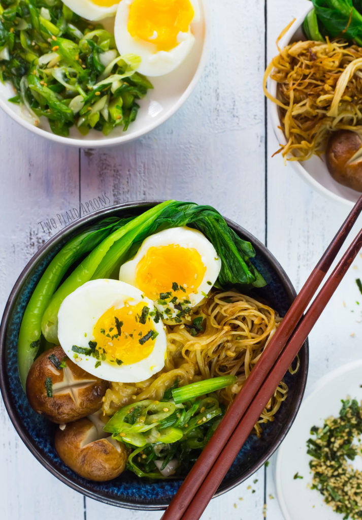 Ramen boils assembled with boiled eggs, bok choi, mushrooms, and marinated green onions.