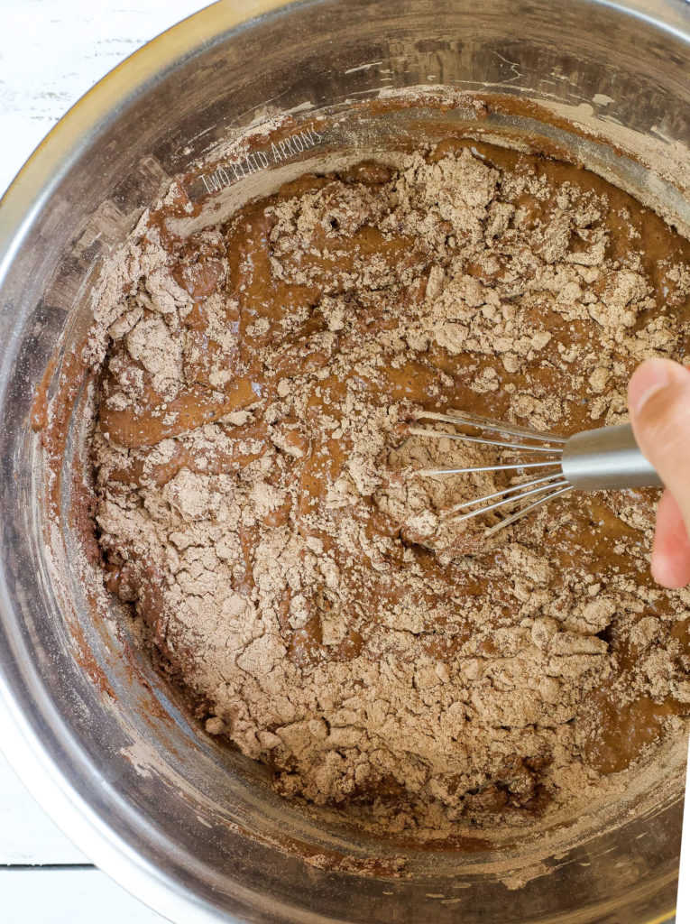 Whisking together dry and wet ingredients.