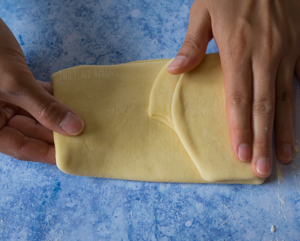 Fold the dough onto itself, pamphlet style to create straight edges.