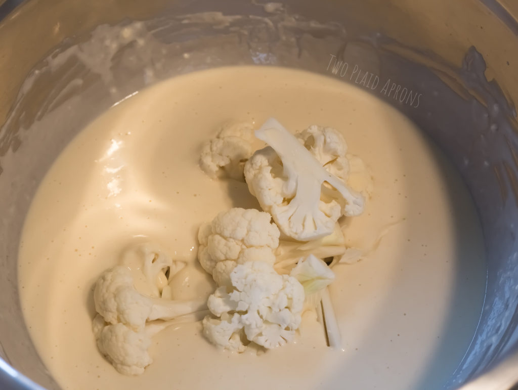 Dredge the cauliflower florets in the wet batter.