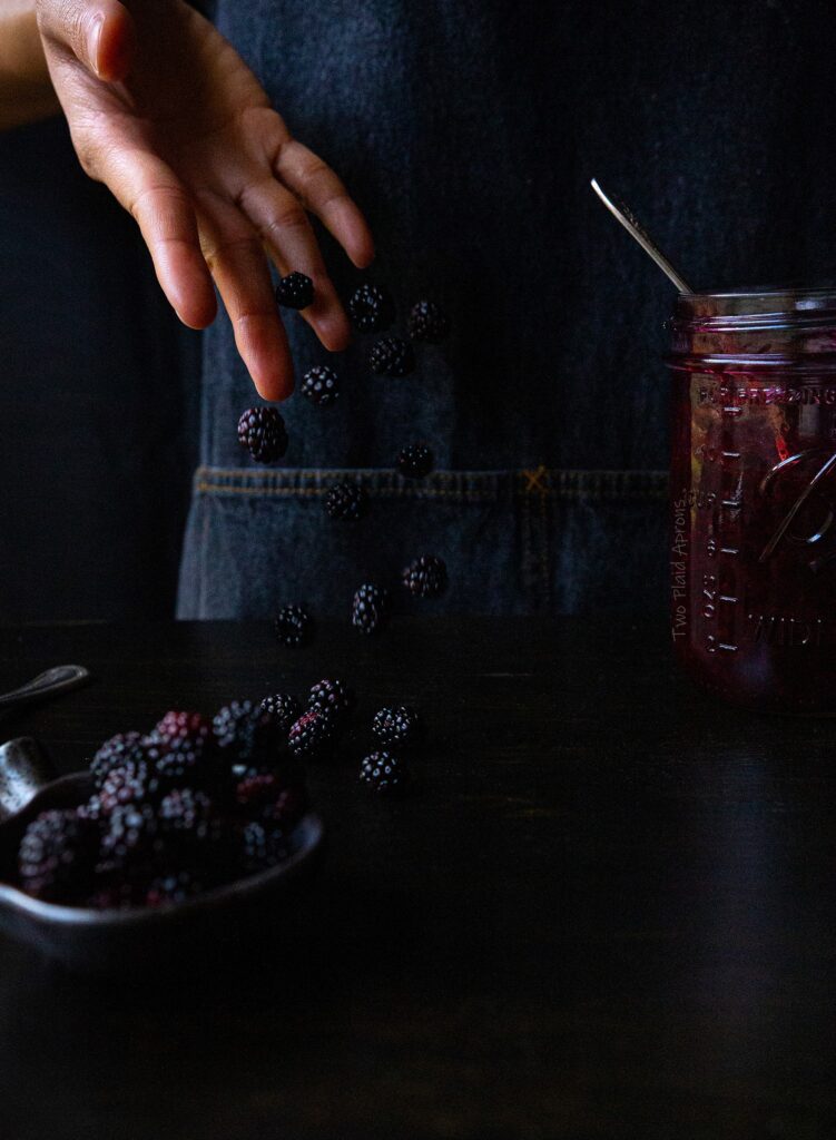 Tossing down a handful of blackberries.