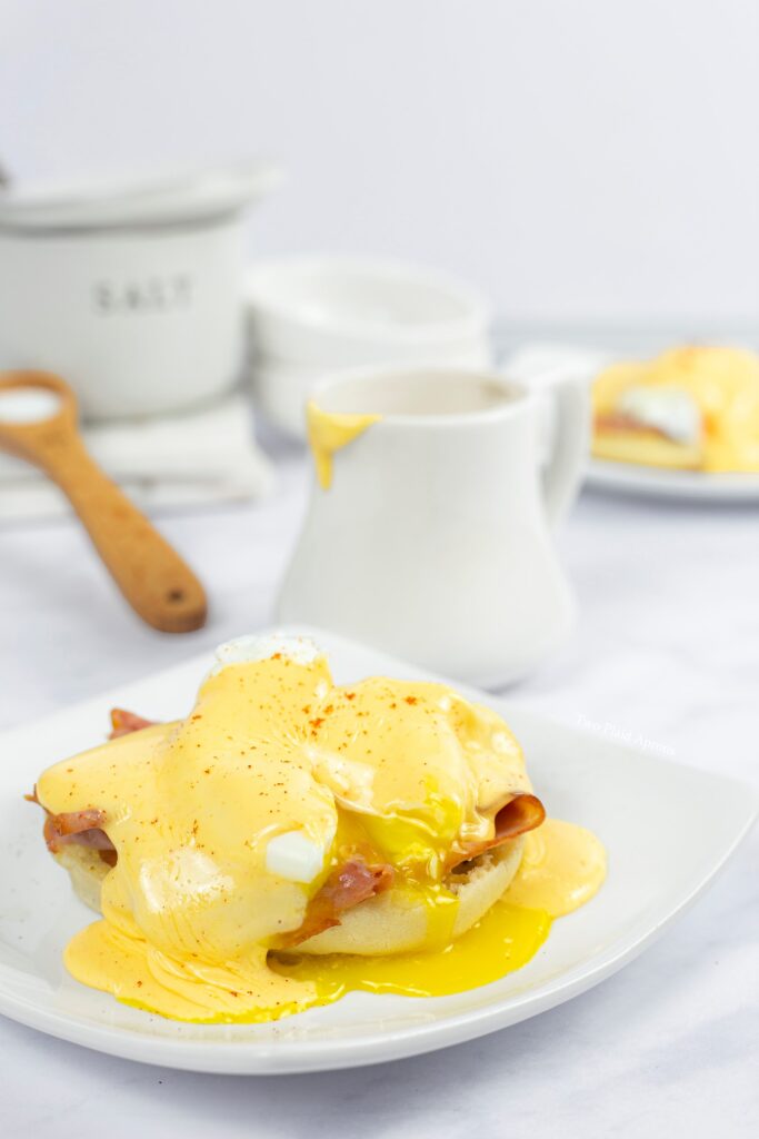 How to make hollandaise: 3 ways - up close of popped egg on eggs benedict.