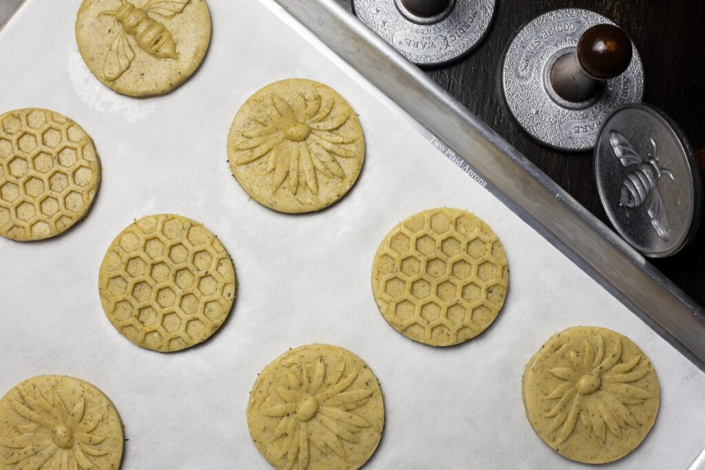 Top view of a tray of cookies with cookie stamps on the side.