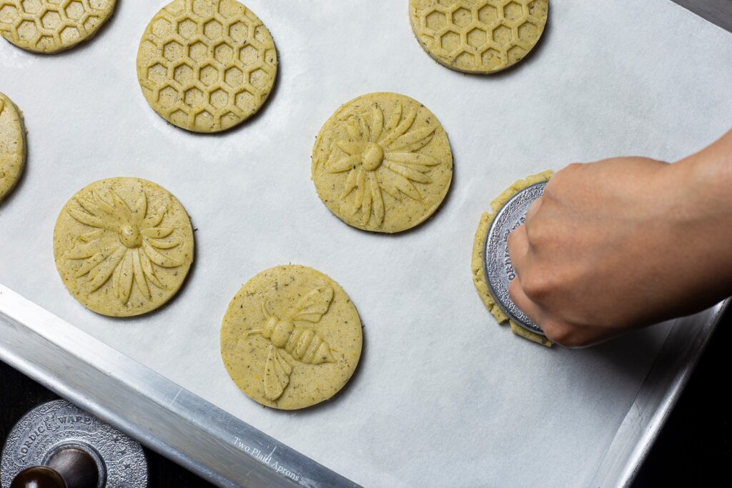 Top view of a cookie being stamped.
