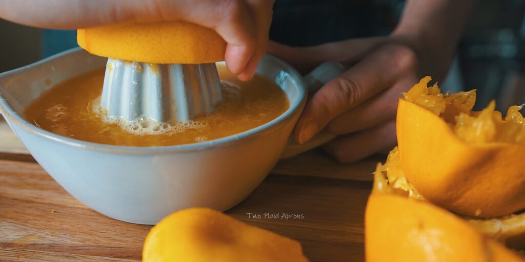 Juicing oranges for the olive oil cake.