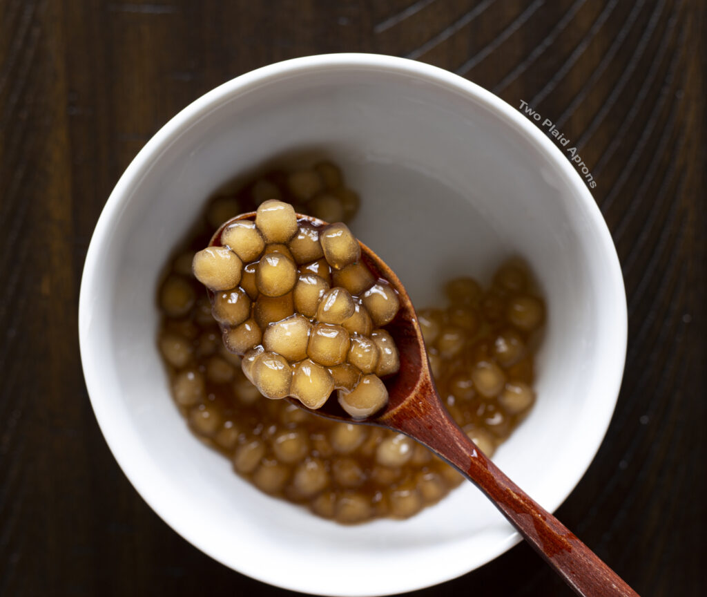 Rinsed cooked boba on a spoon.