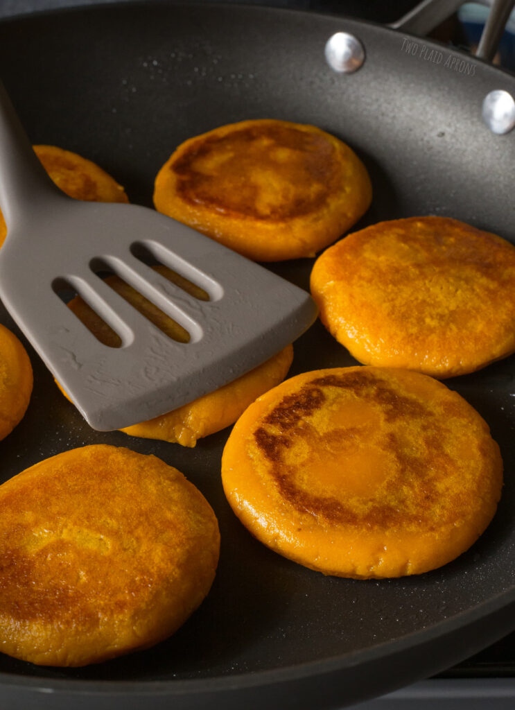 Pan-searing sweet potato mochi pancakes.