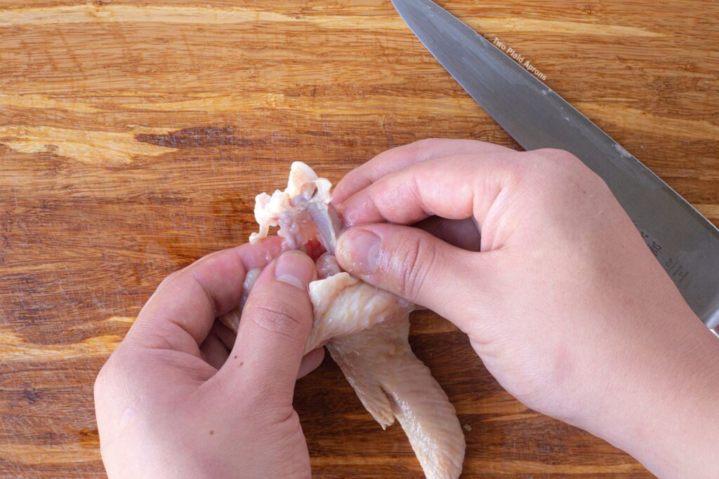 Step 2 of deboning a chicken wing.