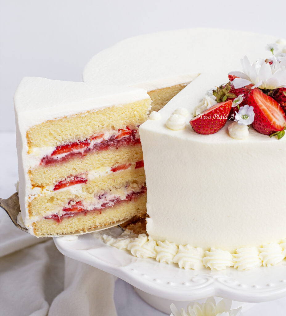 Pulling out a slice of fresh strawberry cake.