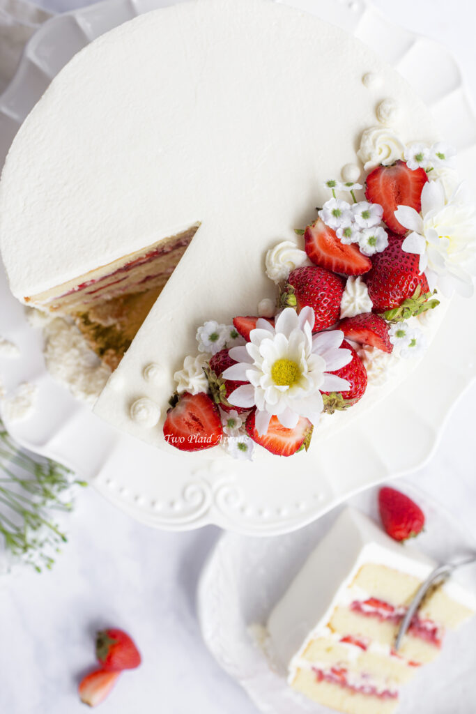Top down shot of the strawberry cake and slice on a plate.