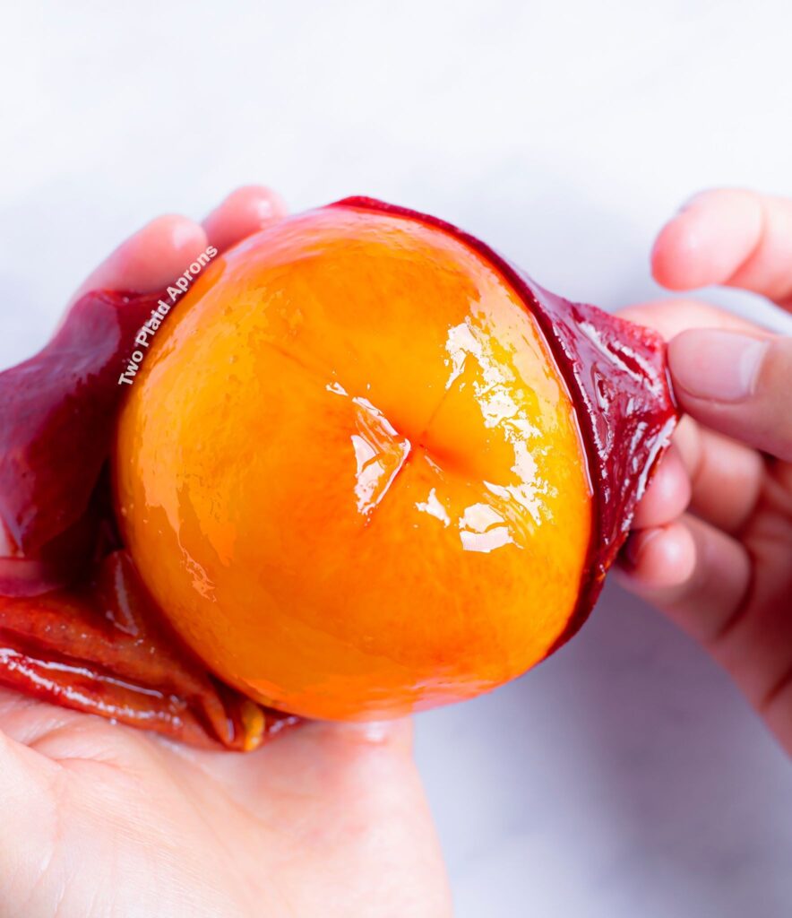 Easily peeling peach skin off of a peach.