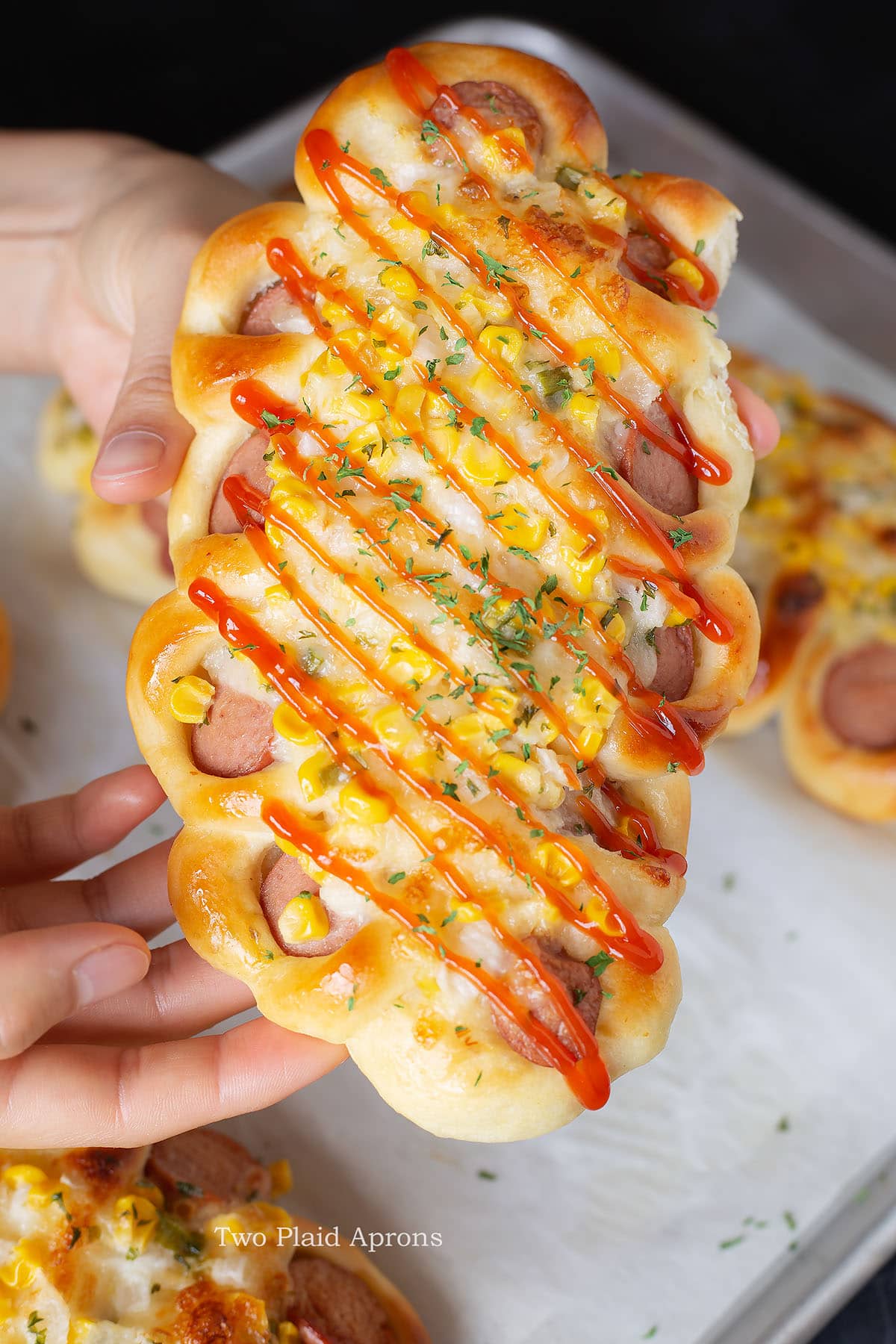 Korean sausage bread being held.