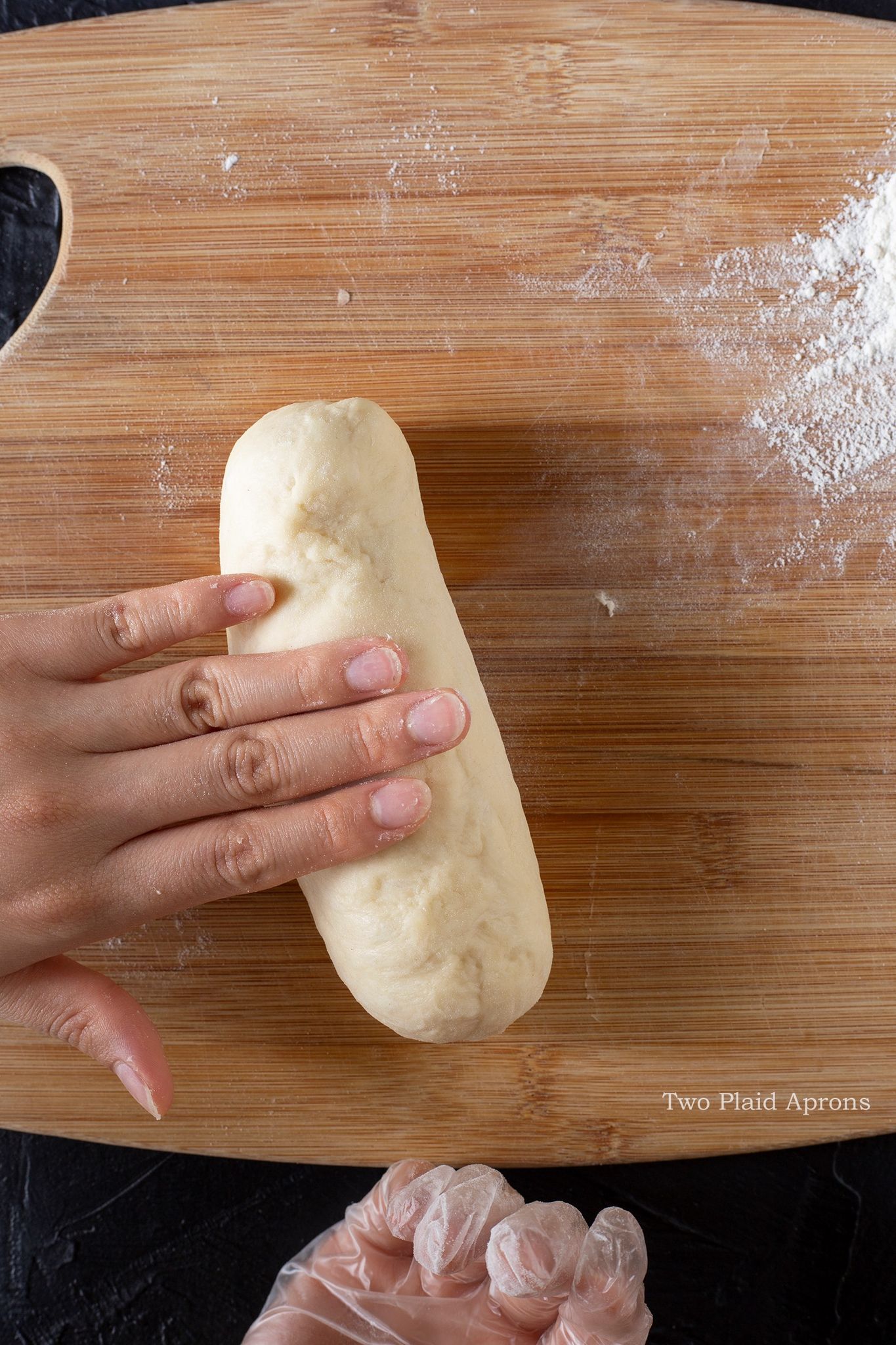 Rolling the dough with sausage in it.