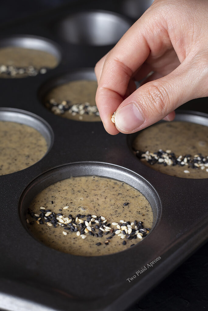 Sprinkling black and white sesame seeds on top of the black sesame mochi muffin batter.