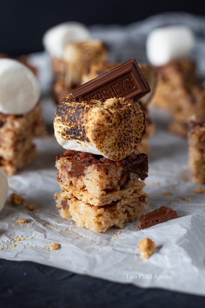 Up close view of s'mores rice krispies topped with toasted marshmallow and Hershey.