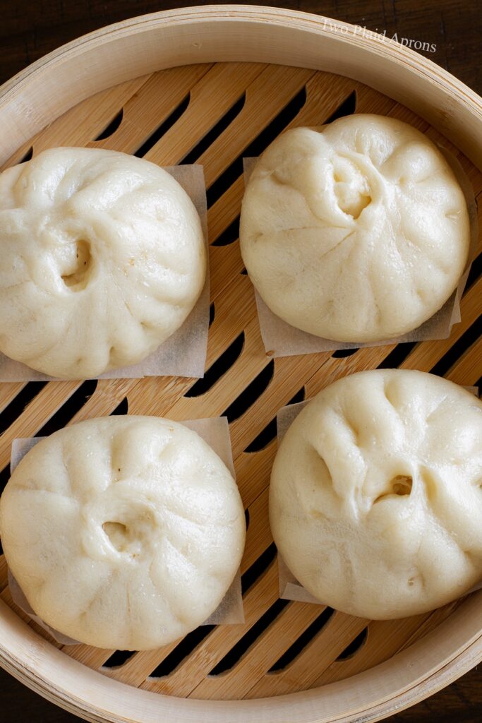 Bao buns on steam basket after steaming.