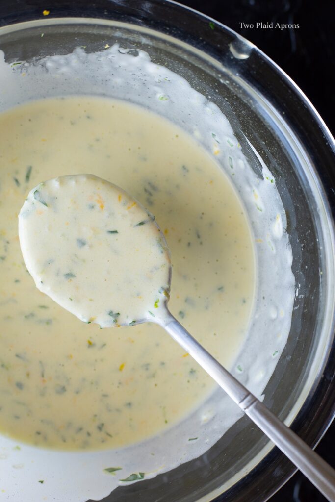 Holding up a spoonful of the creamy citrus vinaigrette.
