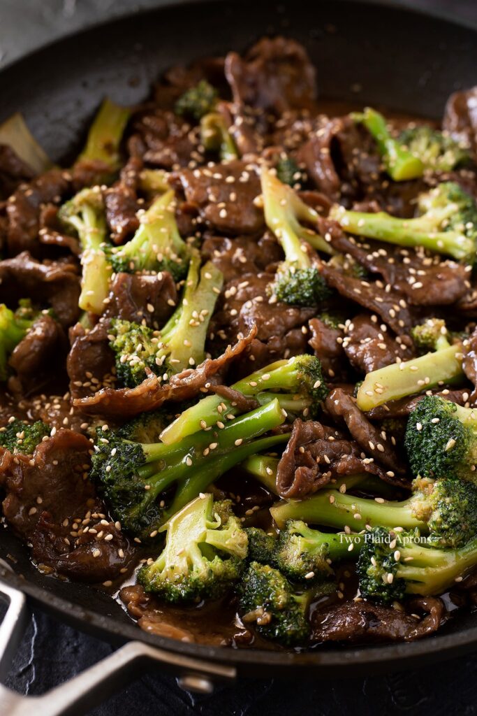 Angled view of beef and broccoli in a pan.
