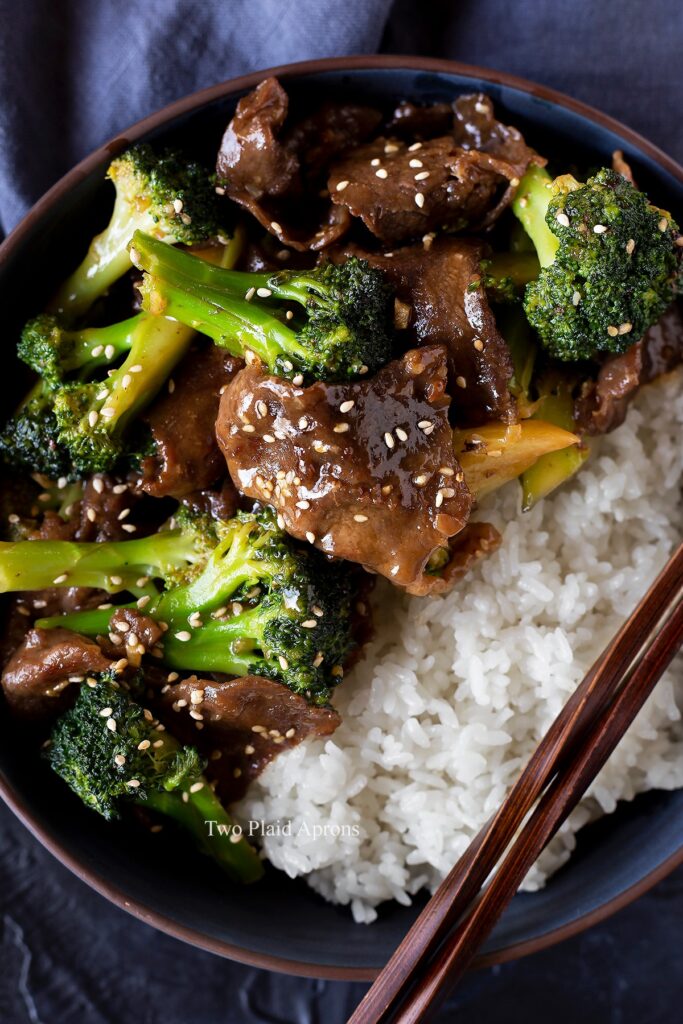 Top down view of beef and broccoli in a bowl with white rice.