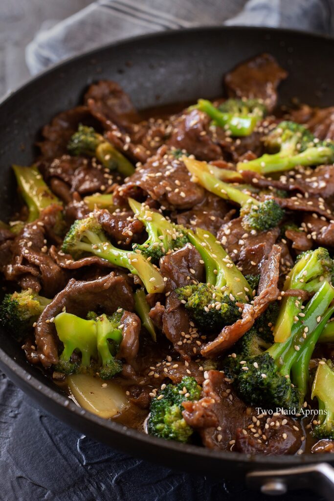 Side, angled view of a pan of beef and broccoli.