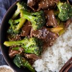 Top down view of beef and broccoli in a bowl with white rice.