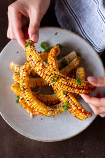 Top down view of holding a Korean corn rib.