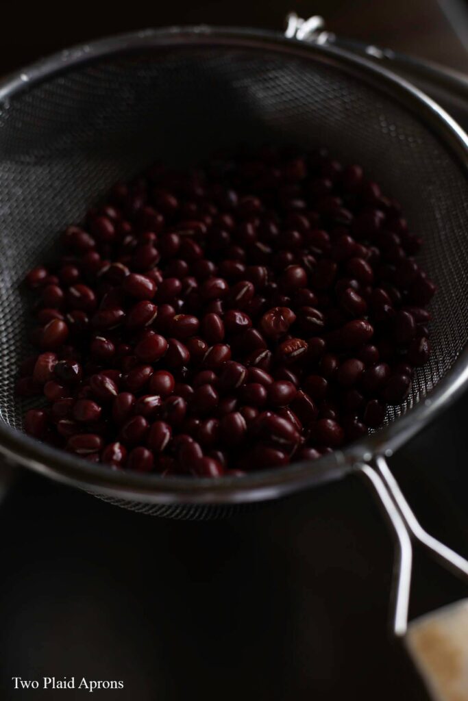 Washed azuki beans draining in a strainer.