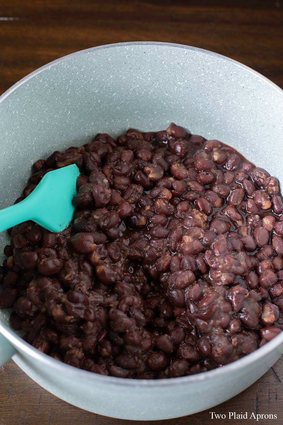 Cooked azuki beans in a saucepan.