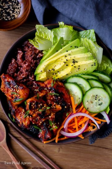 Top down view of a spicy Korean BBQ chicken rice bowl.