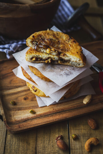 A hotteok cut in half to show the filling oozing.