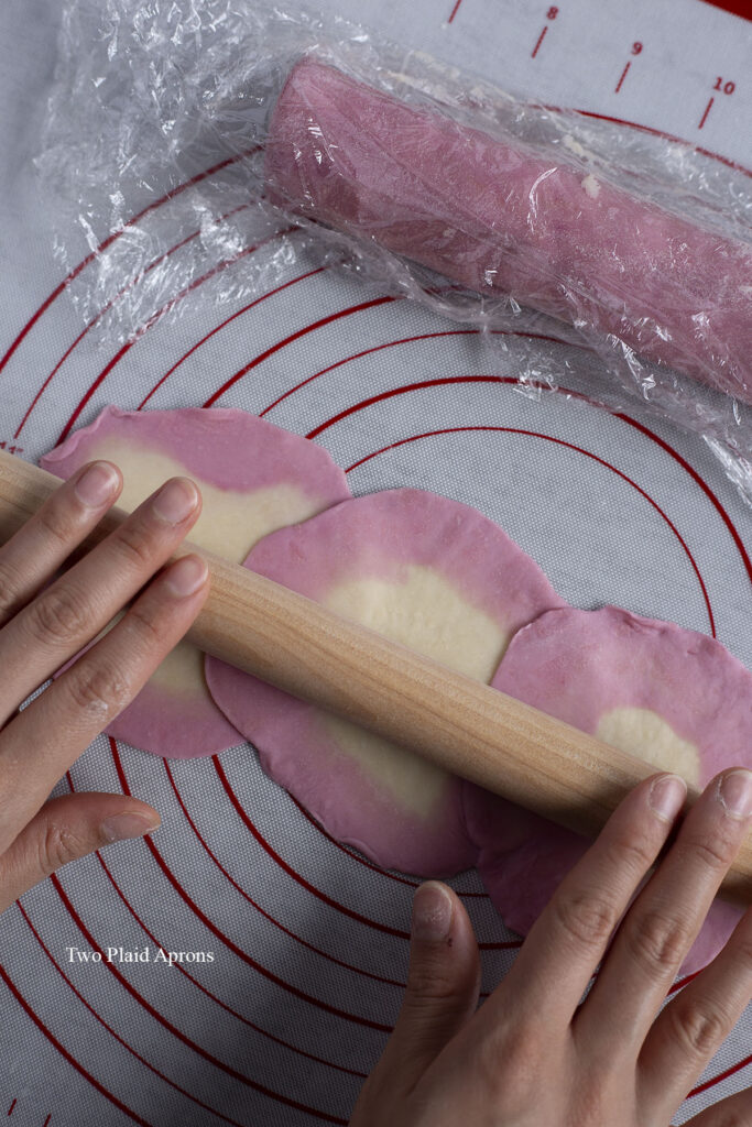 Gently rolling the overlapped dough to help them adhere.