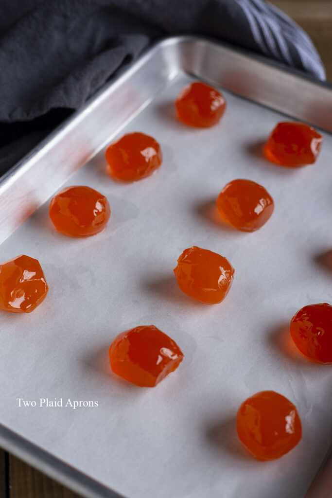 Salted yolks arranged on a sheet pan for baking.