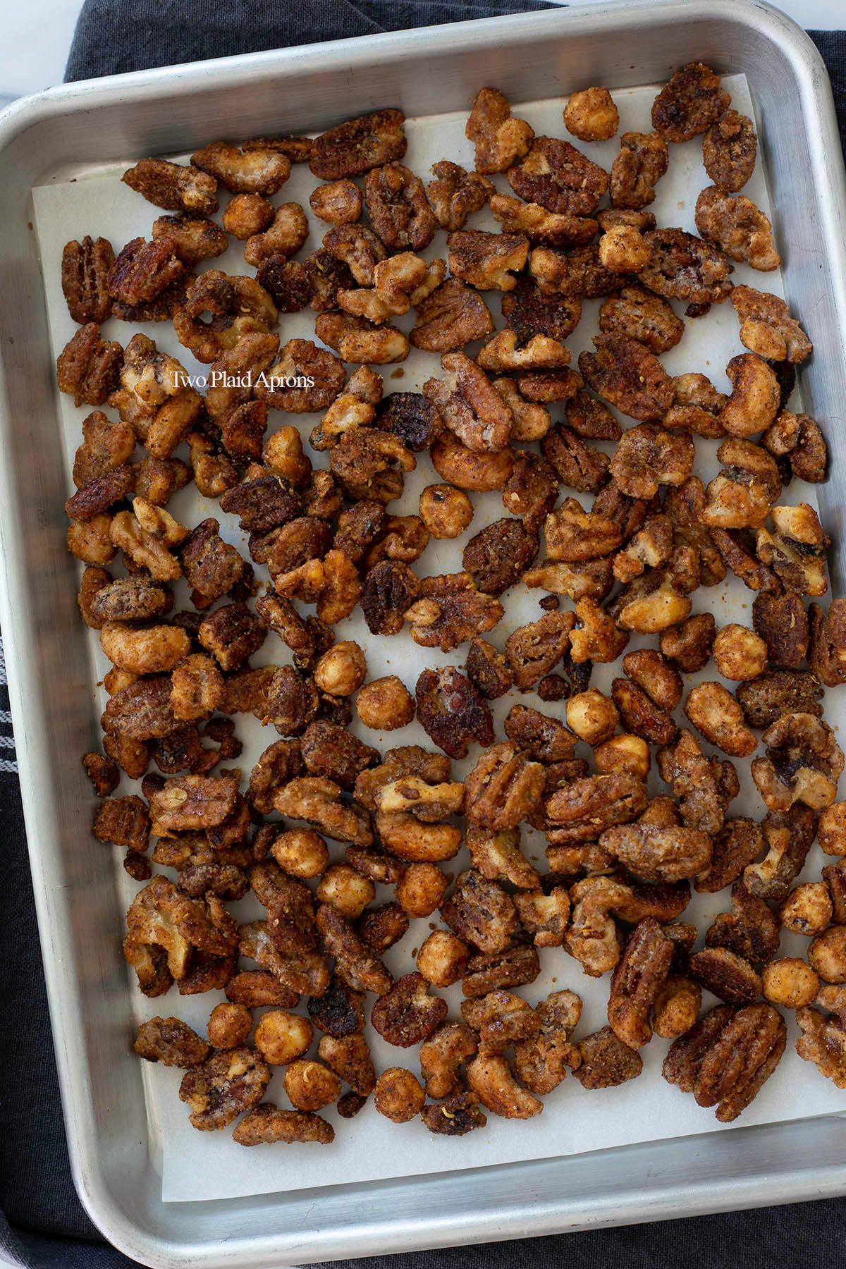 Spiced nuts cooling on baking sheet.