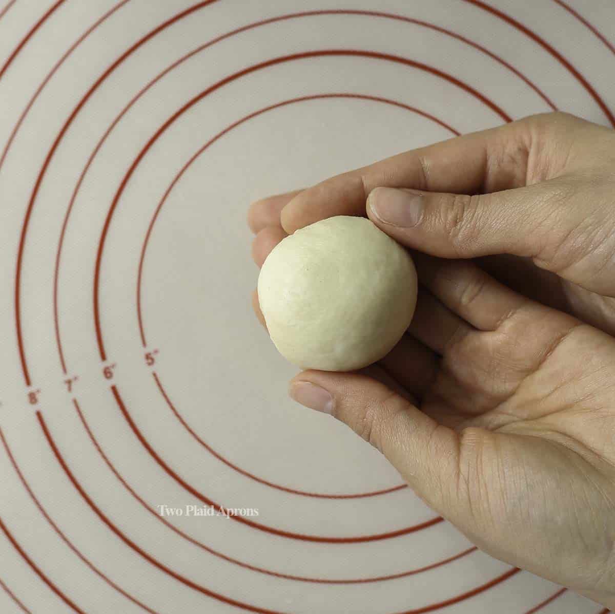 Shaping a milk bread dough ball.