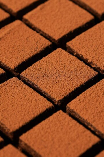 Side angle view of homemade nama chocolate perfectly lined up.