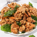 A plate of Taiwanese fried chicken with fried basil.