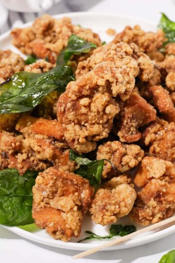 A plate of Taiwanese fried chicken with fried basil.