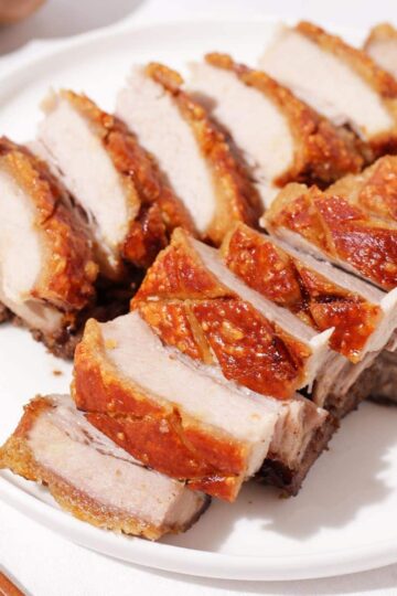 A plate of sliced crispy pork belly.