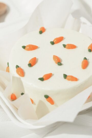 Angle view of a Korean lunch box cake with carrot decorations.
