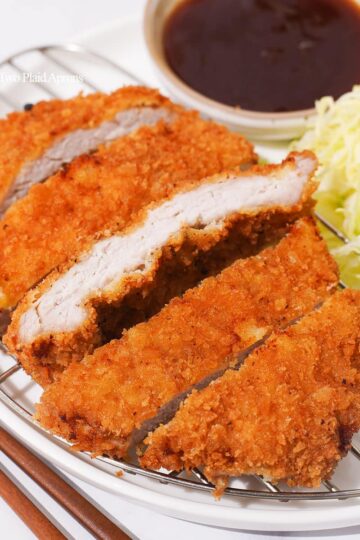 Tonkatsu cut into pieces on a cooling rack.