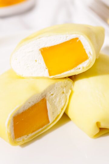Hong Kong mango pancakes stacked on a plate.