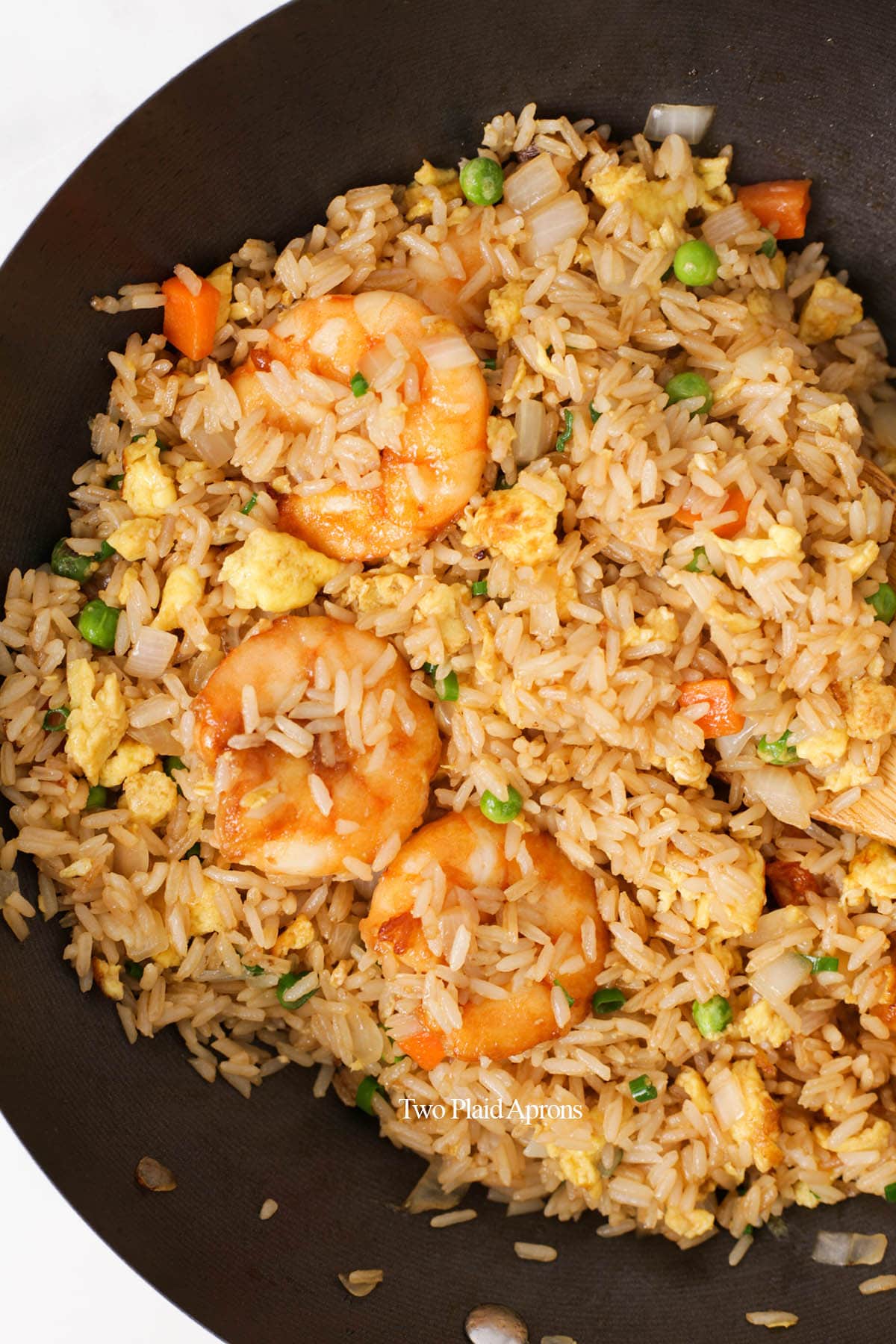 Top down view of shrimp fried rice in a wok.