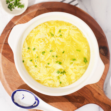 Gluten free egg drop soup garnished with green onions.