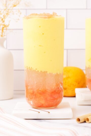 Mango pomelo sago layered in glass cup.