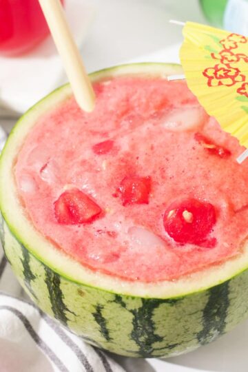 Watermelon soju decorated with a cocktail umbrella.